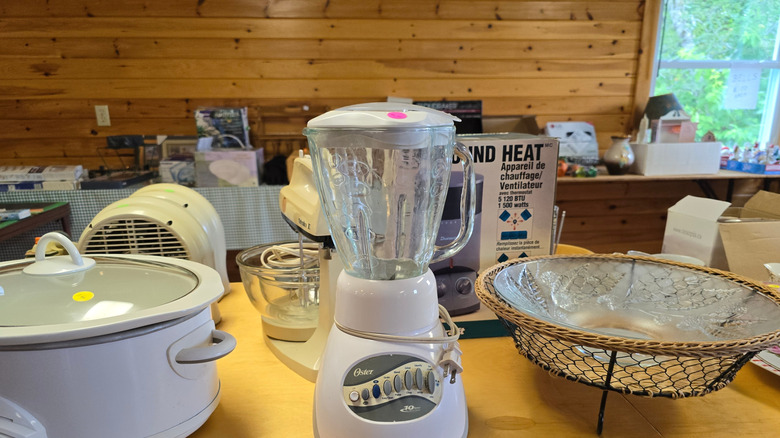 Kitchen items on the table at a yard sale.