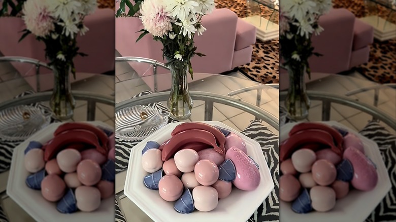 pastel 1980s ceramic fruit set on a glass and chrome table with animal print upholstered chairs
