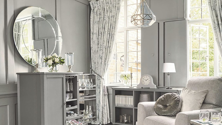 A floral Laura Ashley Turkish rug with matching floral curtain in an overly designed luxe living room.