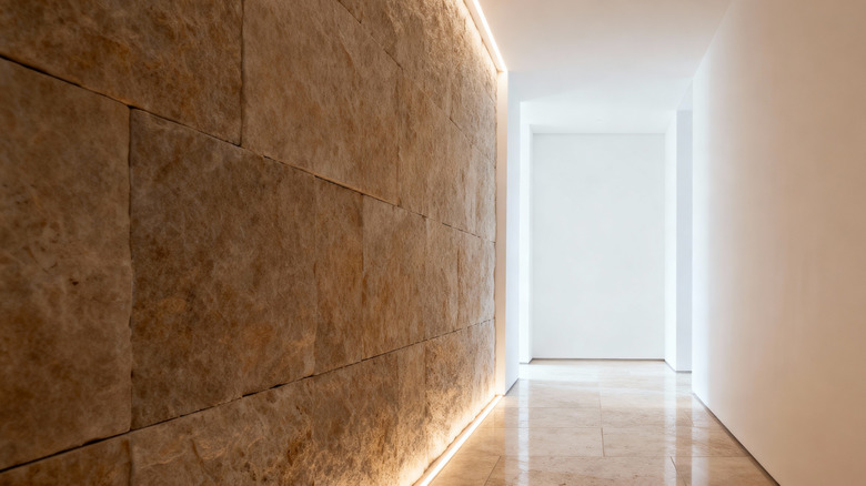 A modern hallway with a stone accent wall.