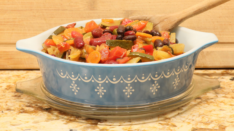 A glass dish filled with a vegetable casserole