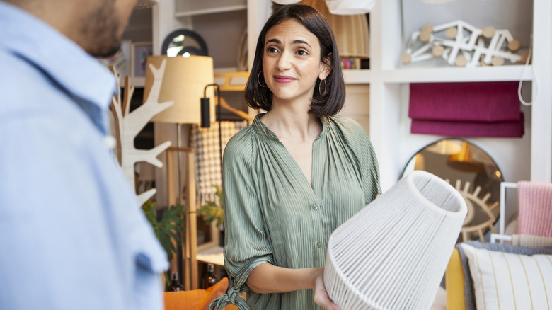Woman looking at lamps in a store