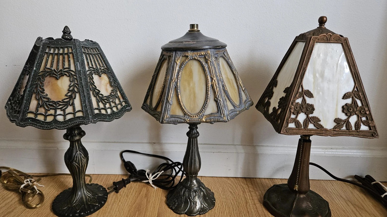 A trio of antique slag glass lamps