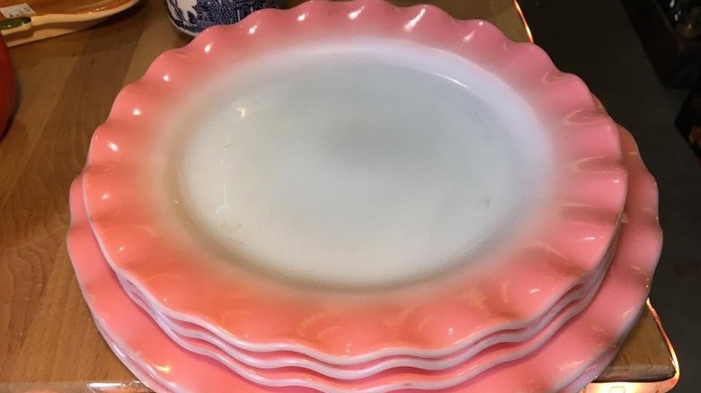 Stack of Pink Crinoline scalloped plates on a table