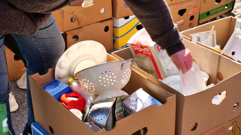 Shopper looking through a box of dishes