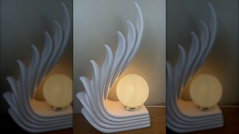A white Art Deco cascading wing lamp glows.