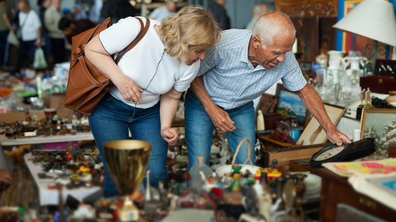 A couple shopping for secondhand items at a flea market