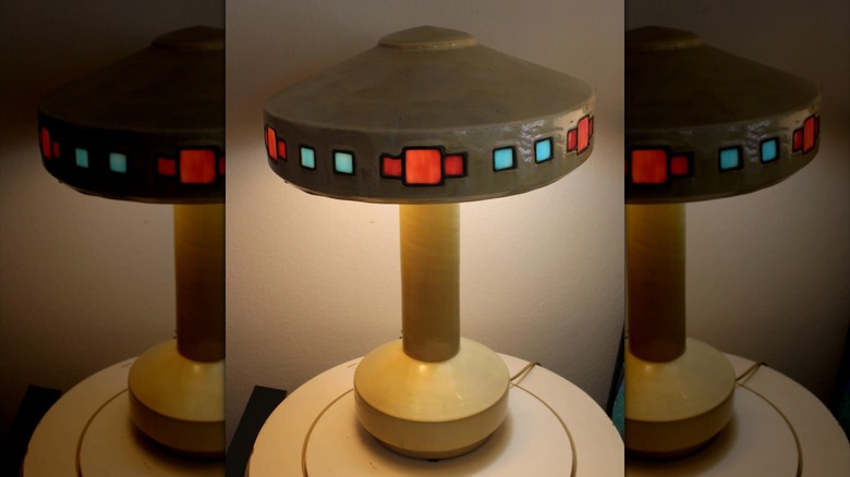 A Fulper Vasekraft lamp with a tan glaze and square art glass embedded in the shade