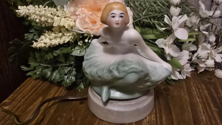 A Fulper boudoir lamp with a cover designed to look like a ballerina