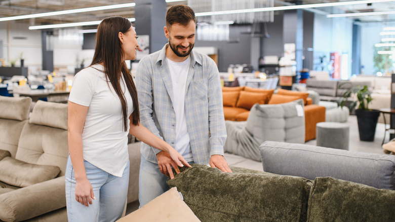 A couple shopping for sofas in a furniture store