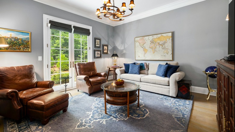 traditional living room with leather English roll arm chairs and an English roll arm sofa