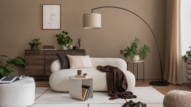 Living room with curved sofa, curvy ottoman, and various curved furniture pieces