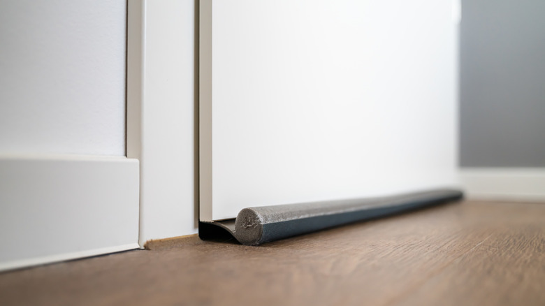 gray door draft stopper on a white door