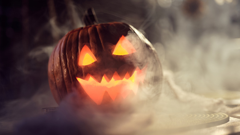 Glowing jack-o'-lantern surrounded by fog
