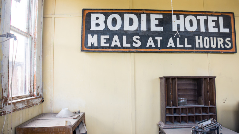 A vintage hotel sign mounted on a wall