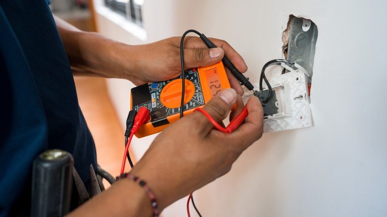 Electrician working on outlet