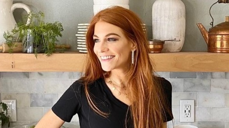 Jenn Todryk smiling by kitchen counter