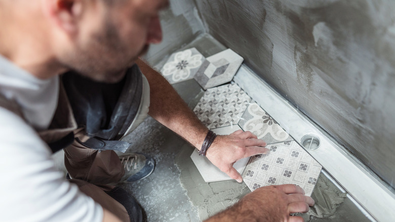 Man tiling a bathroom