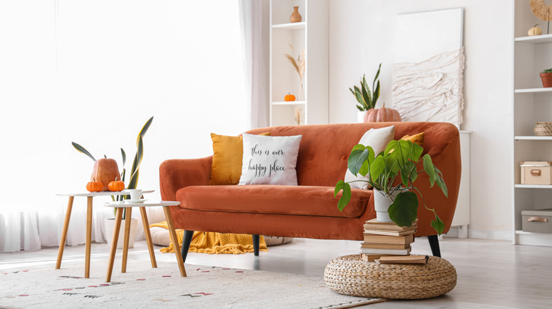 Room styled with orange and texture using white as a canvas