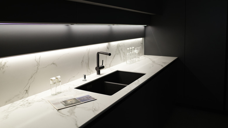 Black kitchen with marble counters