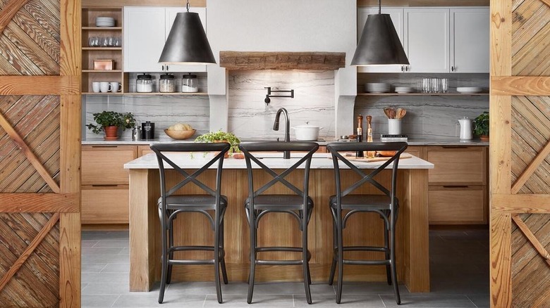 Photo of Joanna Gaines designed kitchen with wood cabinets and white countertops