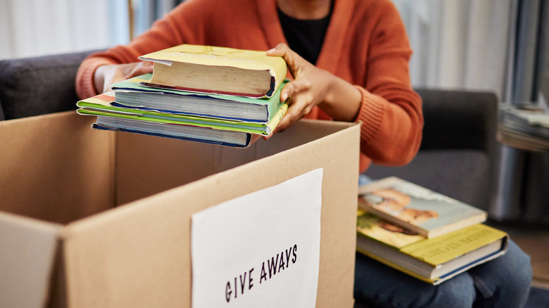 A person packing up books to donate.