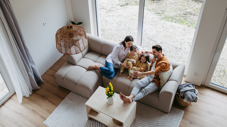 A family sits in living room.