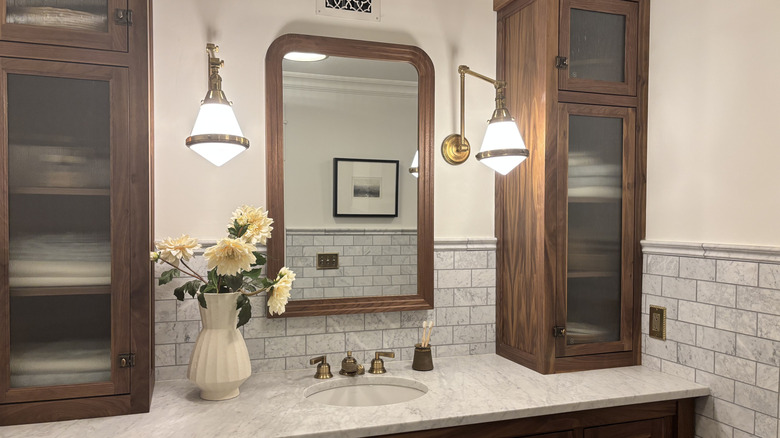Bathroom with wooden shelves and matching wood-framed mirror