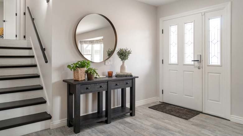 Entryway with light-colored painted walls and floors