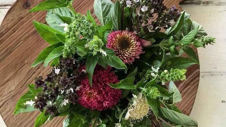 Flower and herb bouquet with basil leaves.