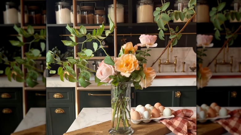 A flower arrangement with orange and pink roses.