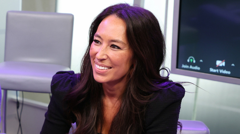 Joanna Gaines smiling in a black shirt.