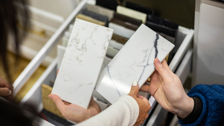 Shoppers holding marble samples in a store