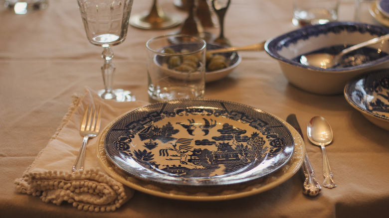 Blue and white dishes on white table setting