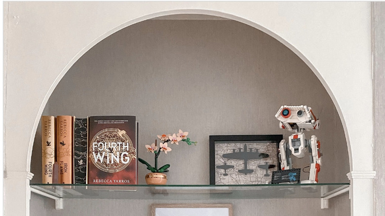 A styled bookshelf with playful decor pieces that brighten the room