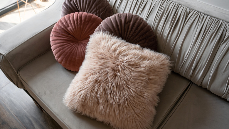 Fur and velvet pillows on a sofa