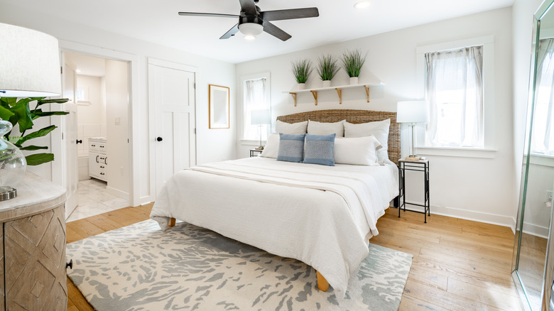 White bedroom with gray accents and printed rug