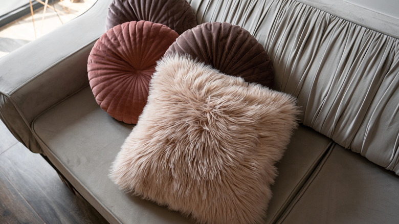 Fur and velvet pillows on a sofa