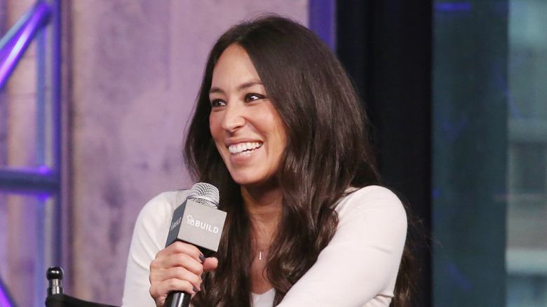 Joanna Gaines holding a microphone during a TV guesting