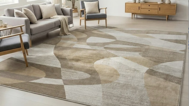 Product image of the Costco Eden Area rug in the living room, couches and chairs.