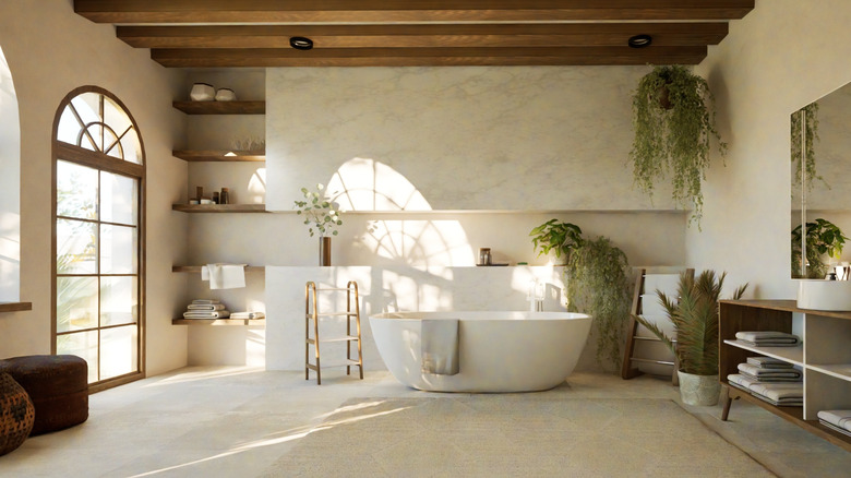 Bathroom with freestanding tub and wood beams on ceiling