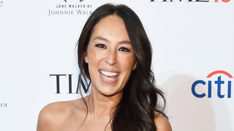 Joanna Gaines smiles for photos on a red carpet