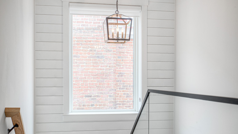 shiplap wall with window and lavender in basket