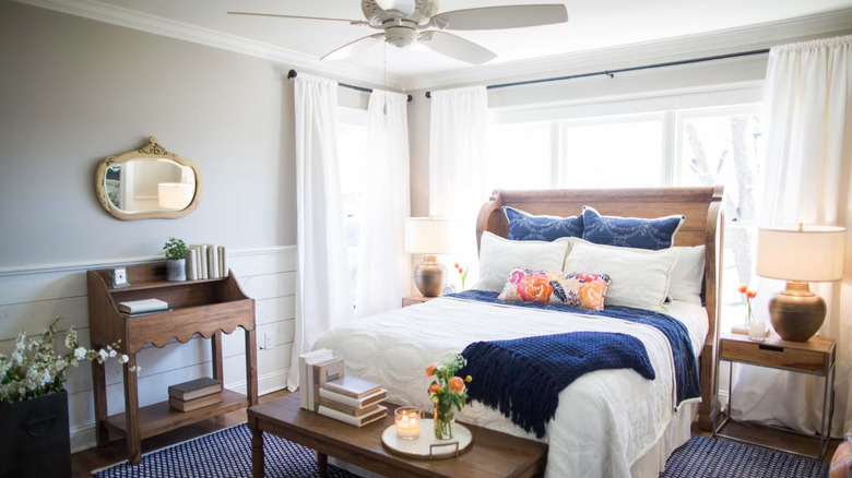 bedroom with white and grey shiplap wall, navy and white color palette and wood accents