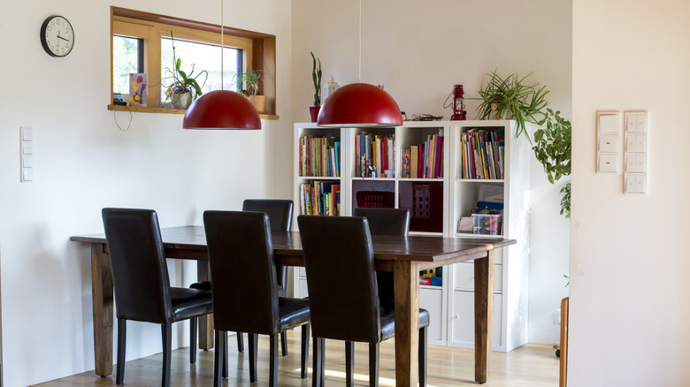 Bookcase in dining room behind table