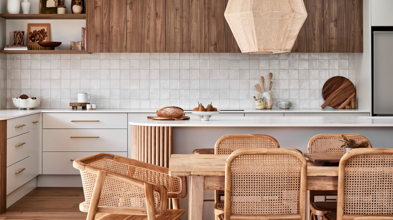 A small rustic kitchen features a curved island with wood detailing