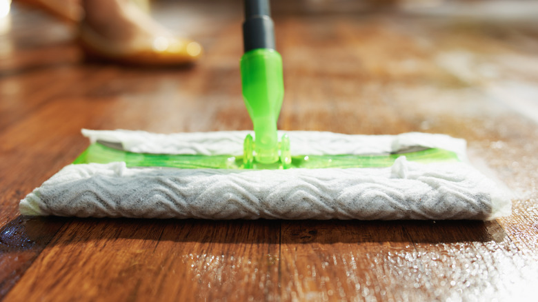 Closeup of mop head cleaning a wood floor.