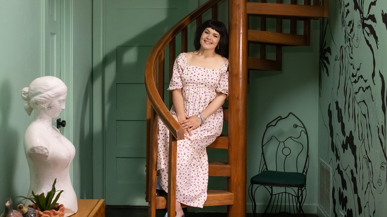 Katie Saro smiling on spiral staircase