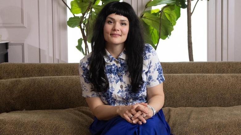 Katie Saro sitting on couch 