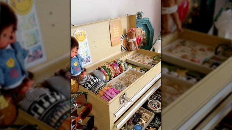 A toolbox transformed into a jewelry box with organizers and decor